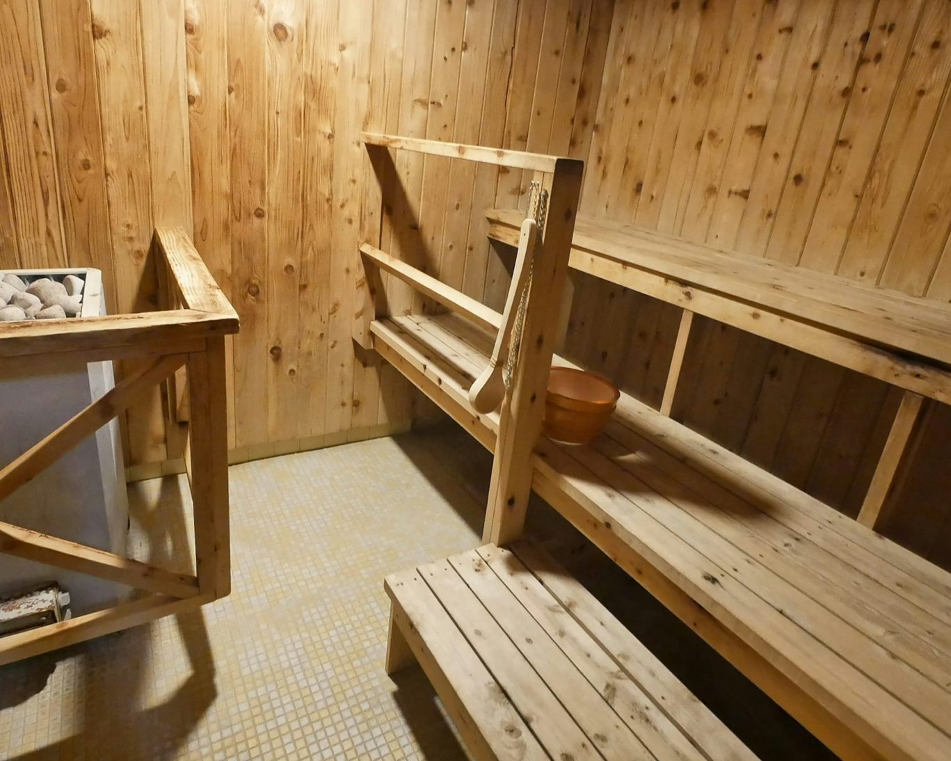 Wooden sauna with benches and heater at Magnuson Hotel Copper Crown.