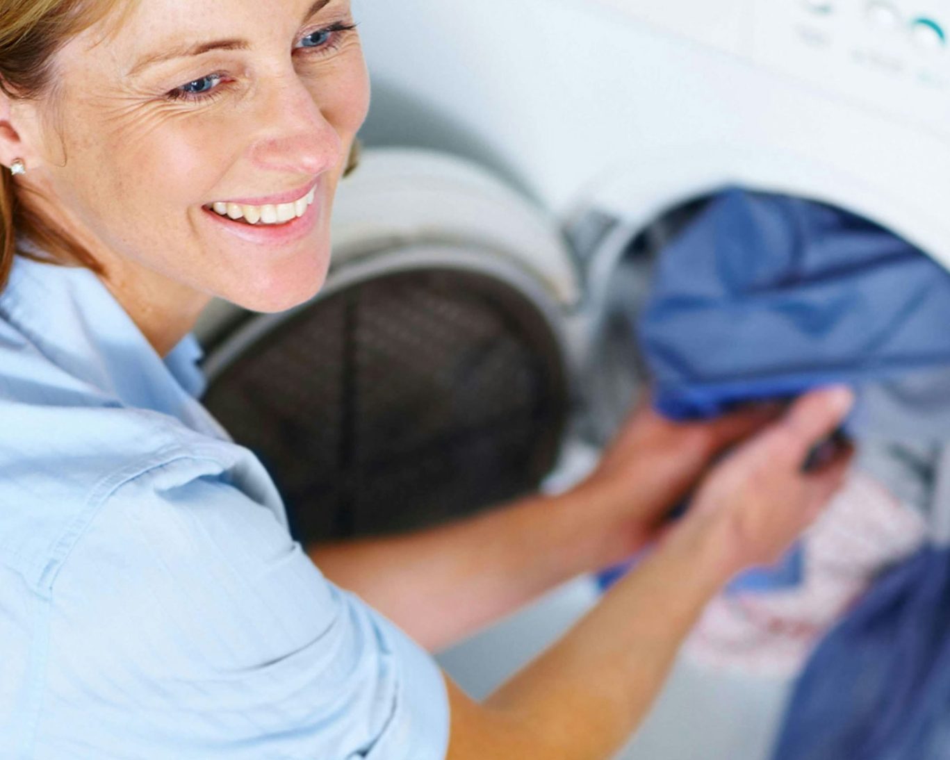 Guest using on-site laundry facilities at M Star Hotel Mansfield.