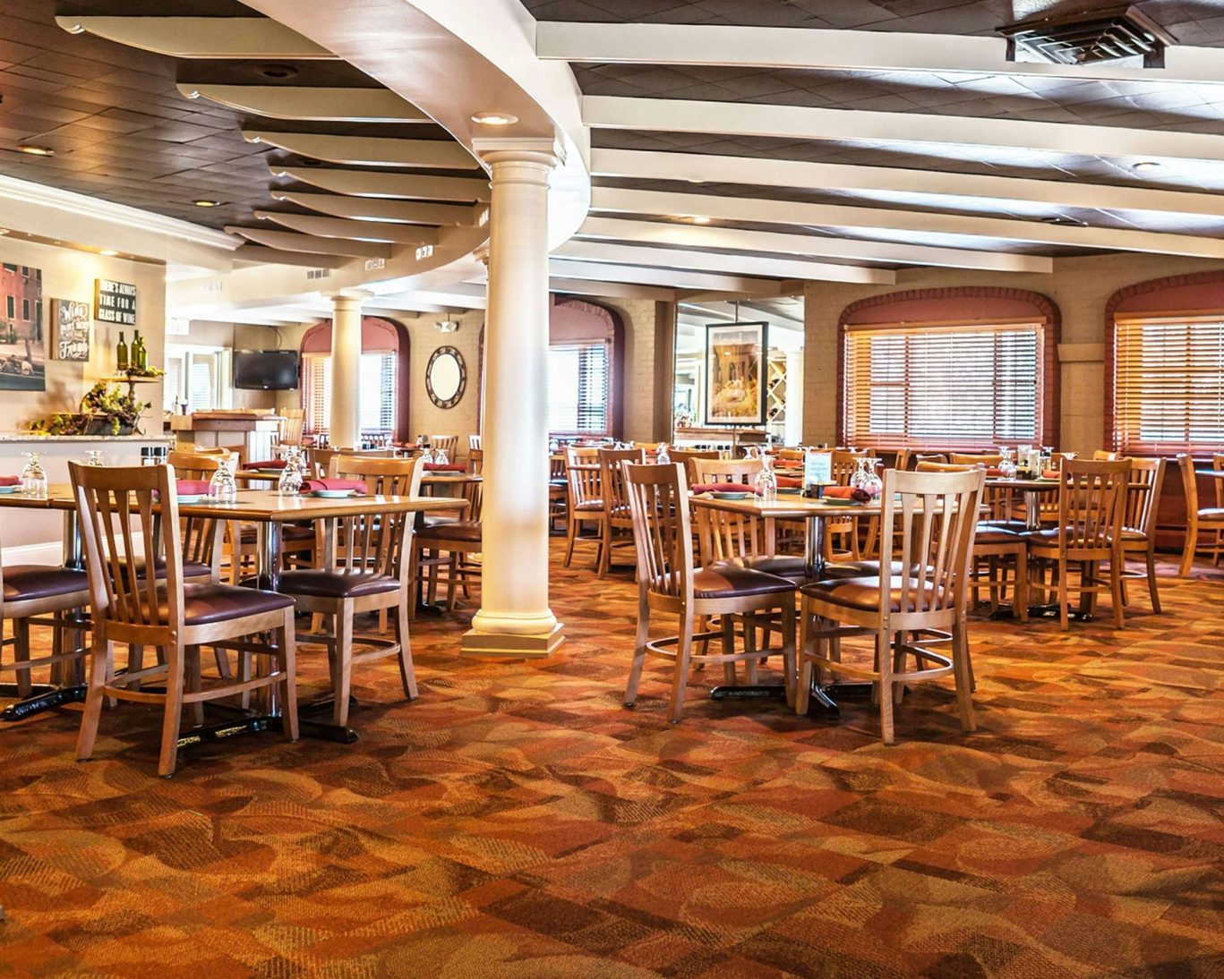 Spacious hotel restaurant dining area with warm lighting and wooden furniture at Jamestown Grand.