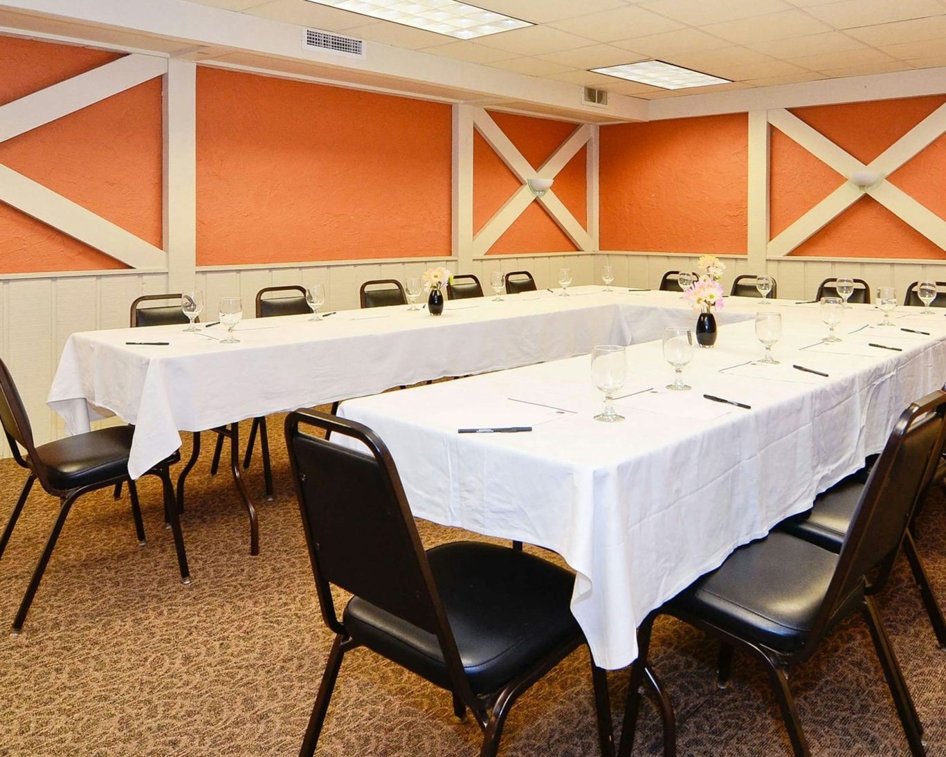 Well-lit hotel meeting room at Jamestown Grand with U-shaped table setup and professional ambiance.