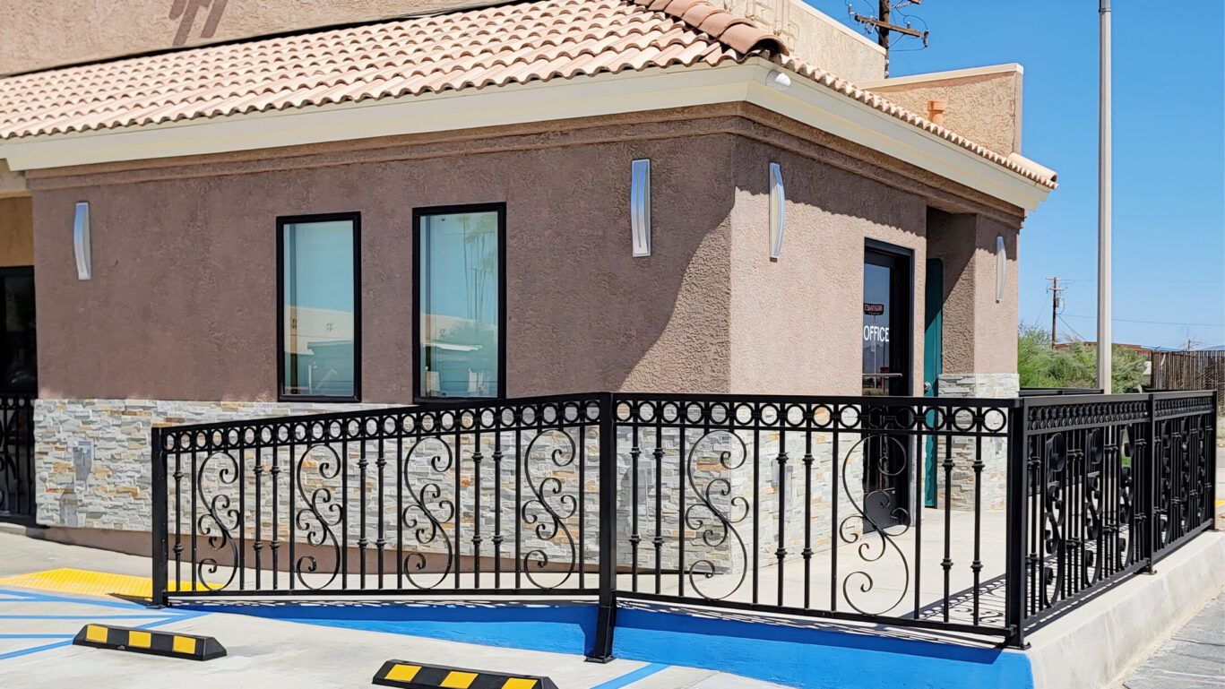 Front exterior of Magnuson Hotel Blythe with logo signage under a clear blue sky.