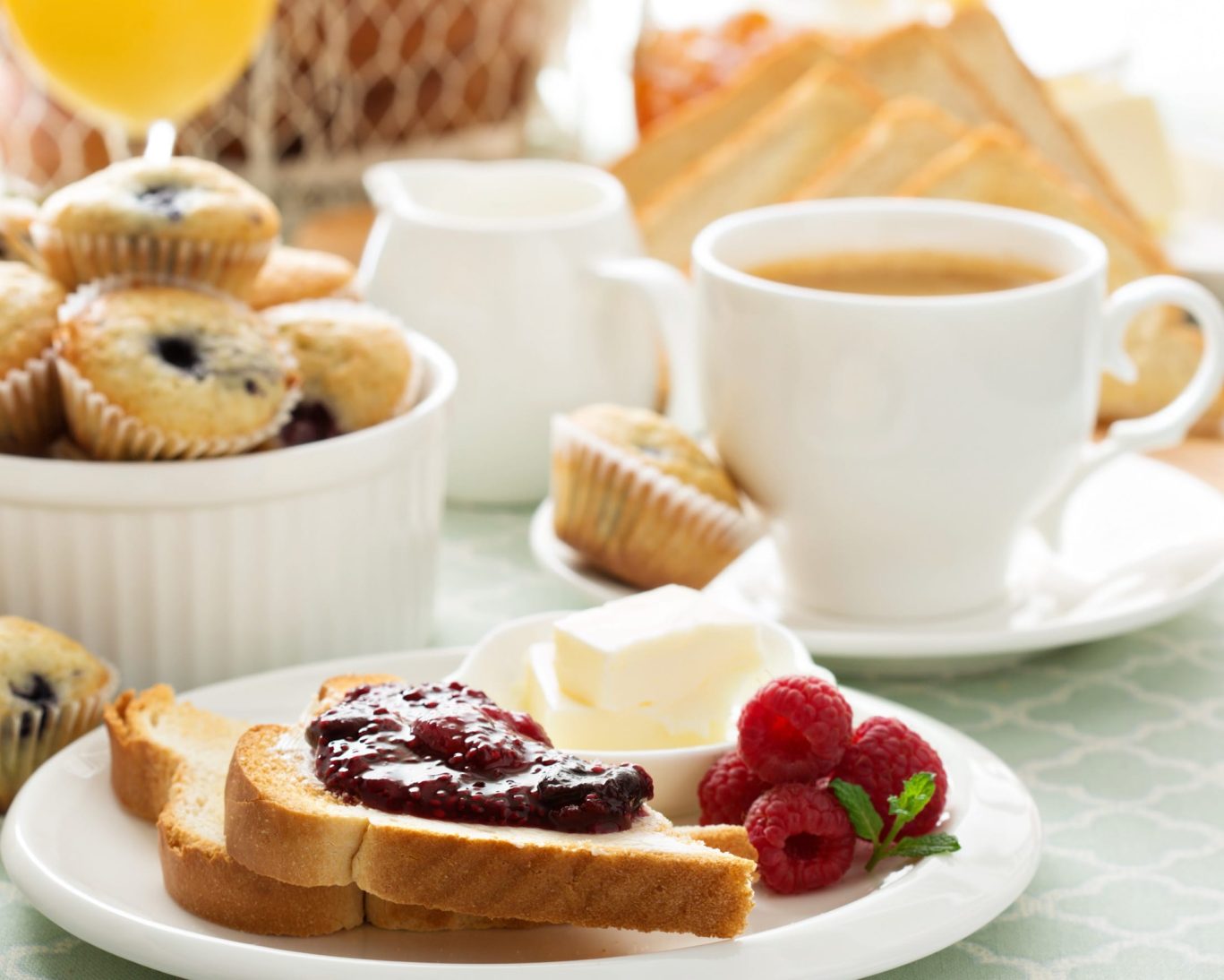 Complimentary continental breakfast with toast, jam, fresh raspberries, and coffee at Magnuson Hotel.