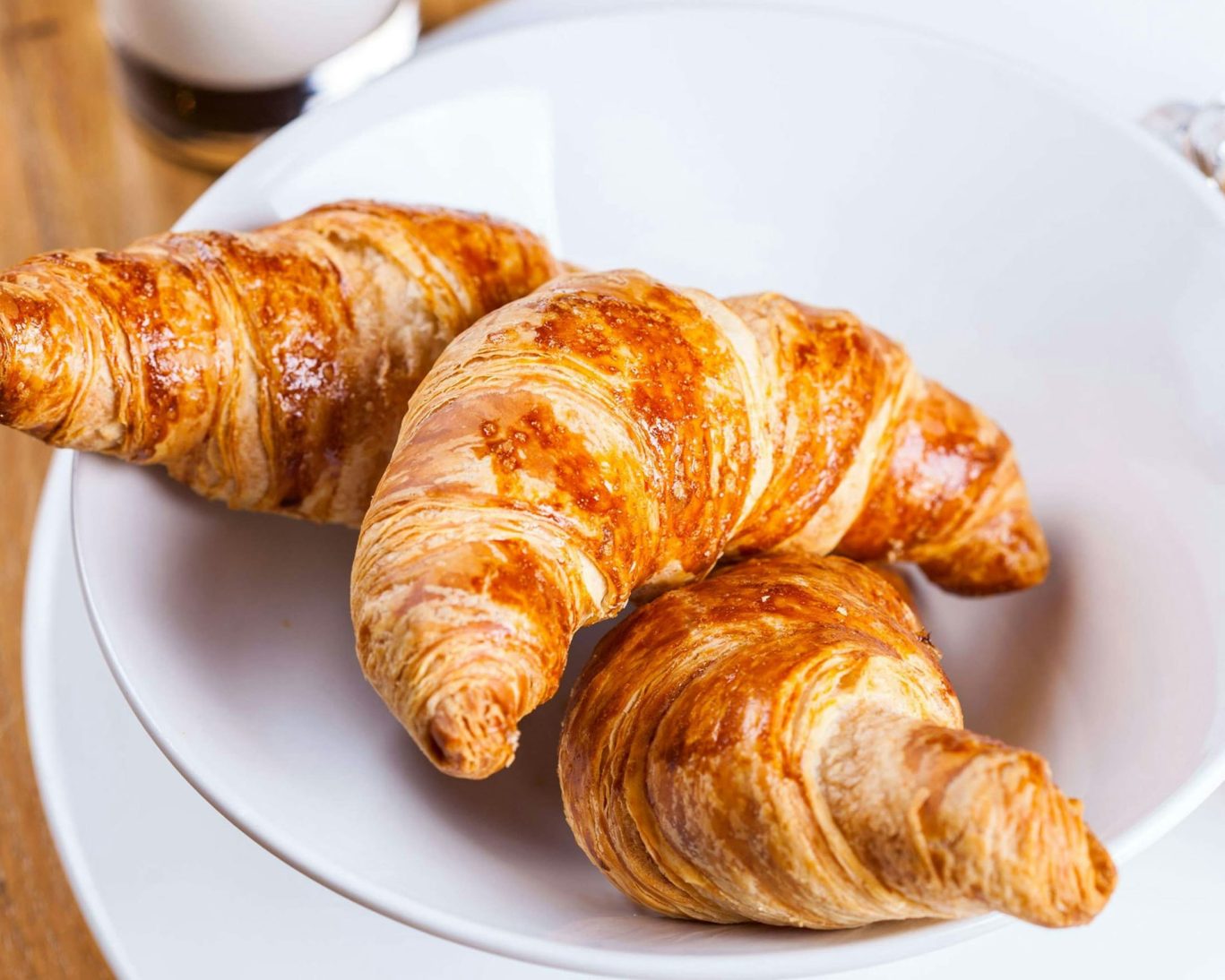 Close-up of fresh buttery croissants served at Magnuson Hotel breakfast.