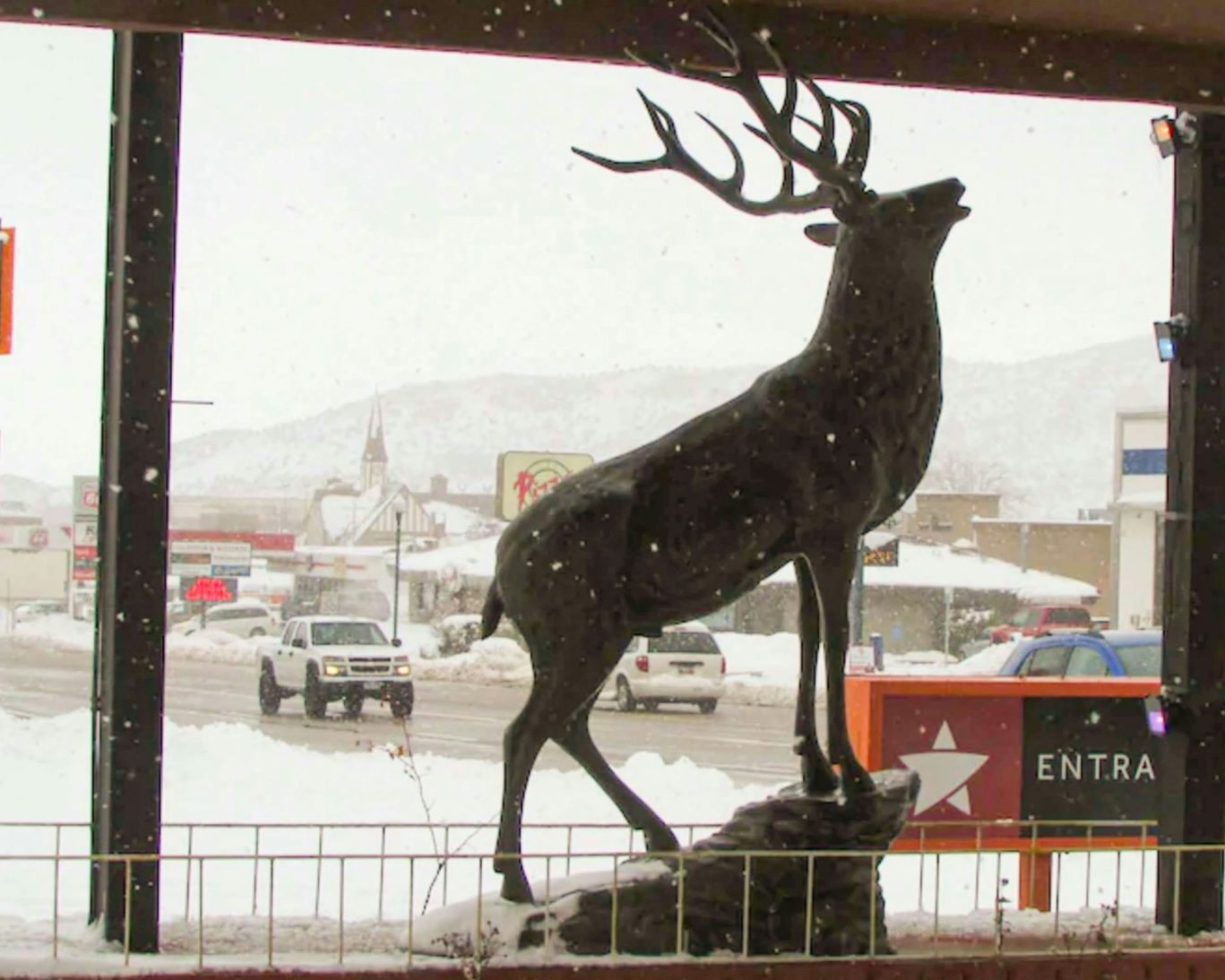 Elk statue outside Magnuson Hotel with snowy Cedar City backdrop.