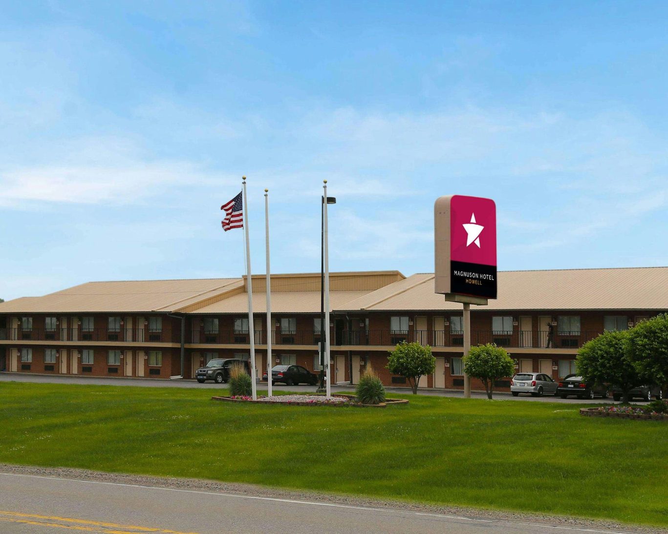Exterior view of Magnuson Hotel Fowlerville with branded signage near the main entrance.