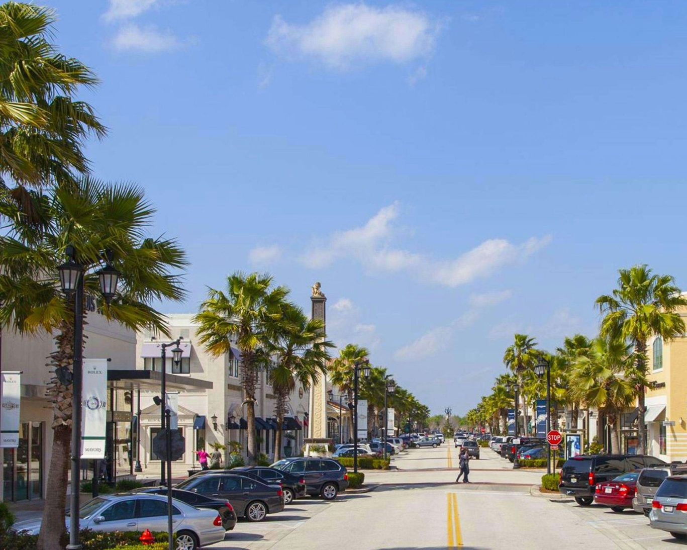 Outdoor shopping district in Jacksonville, Florida with palm-lined streets and retail stores.