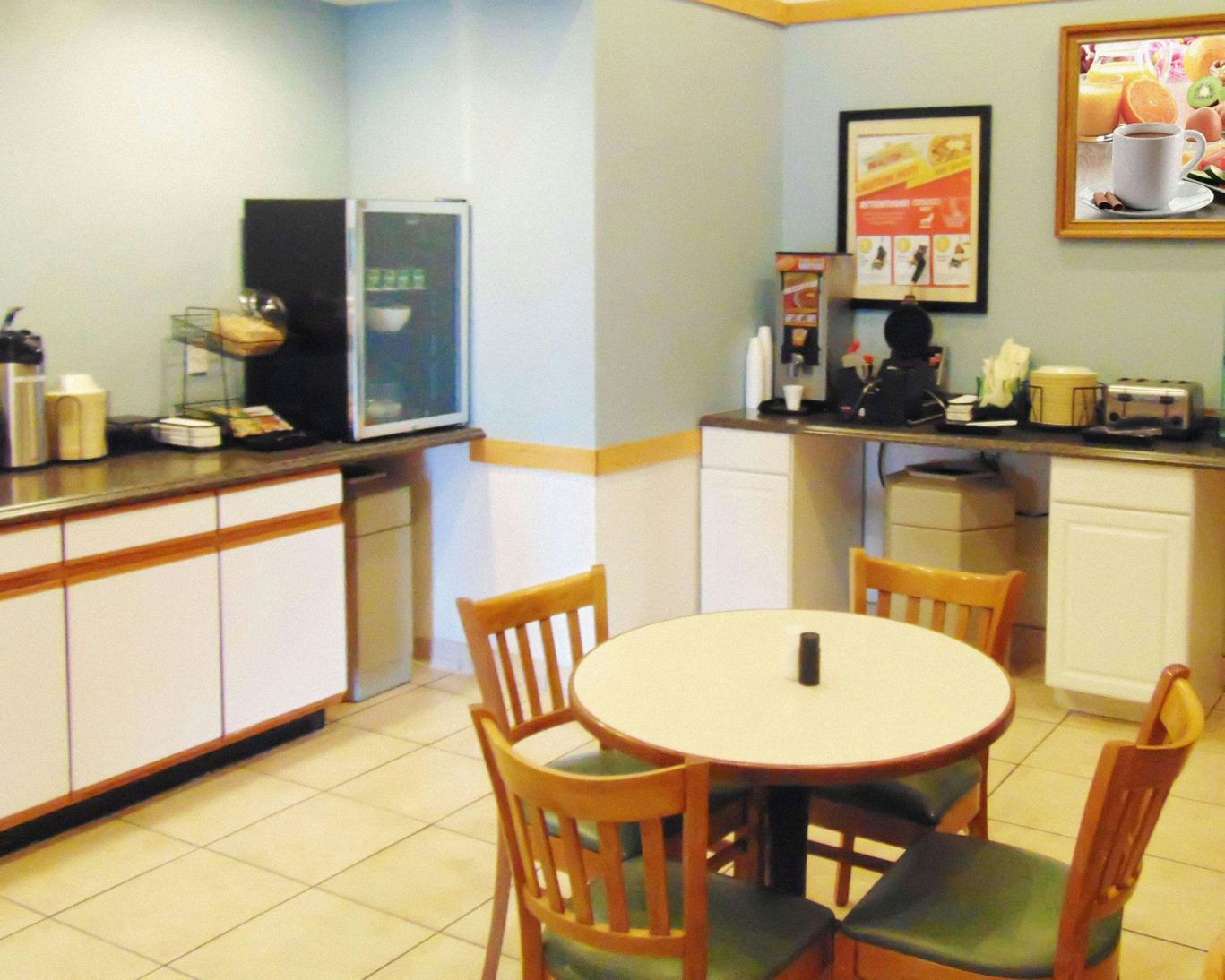 Magnuson Hotel Manitou Springs breakfast area with coffee station and dining table setup.