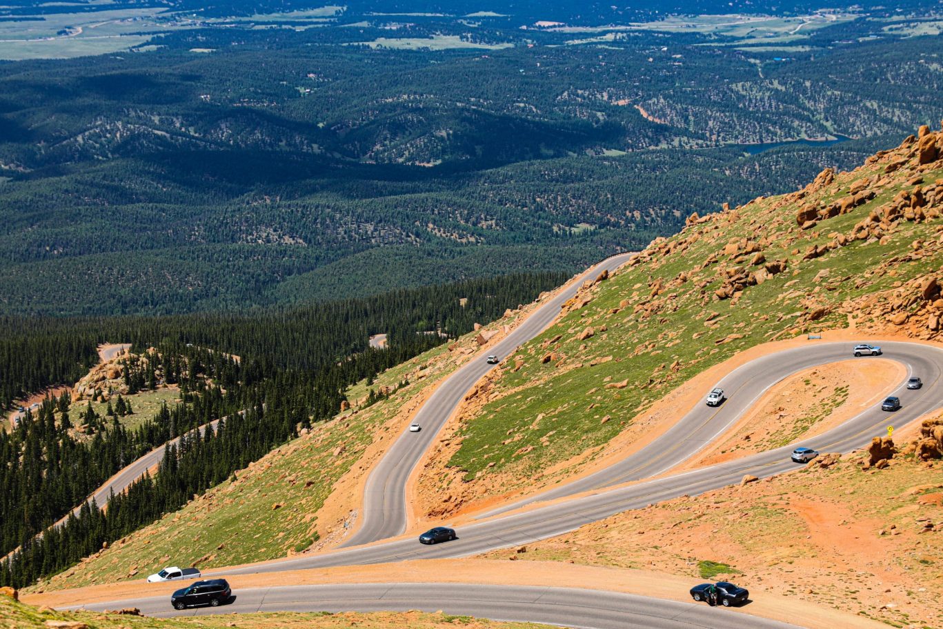 Scenic view of Pikes Peak Highway with winding roads through mountainous terrain in Colorado.