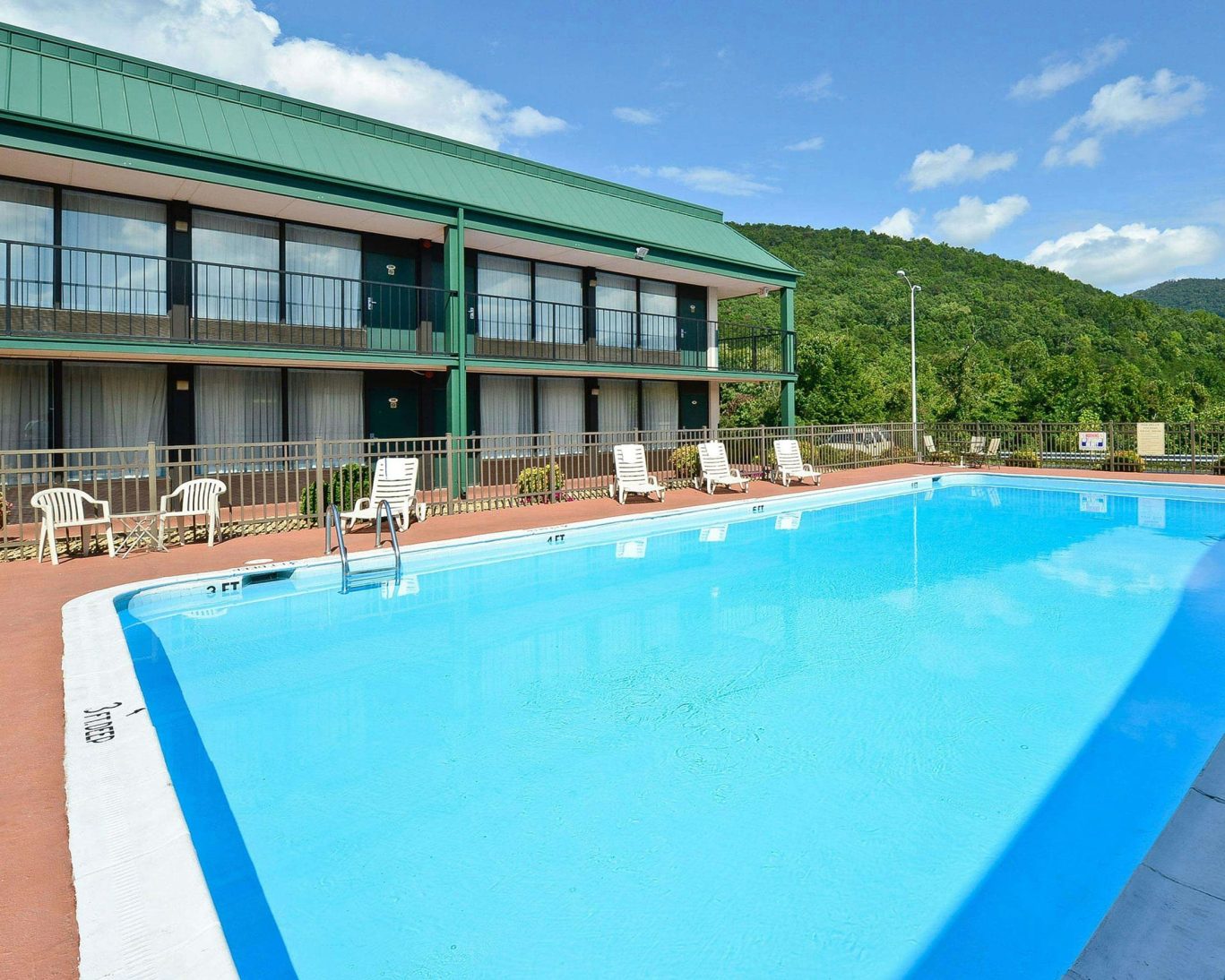 Seasonal outdoor pool at Georgia hotel with scenic mountain backdrop.