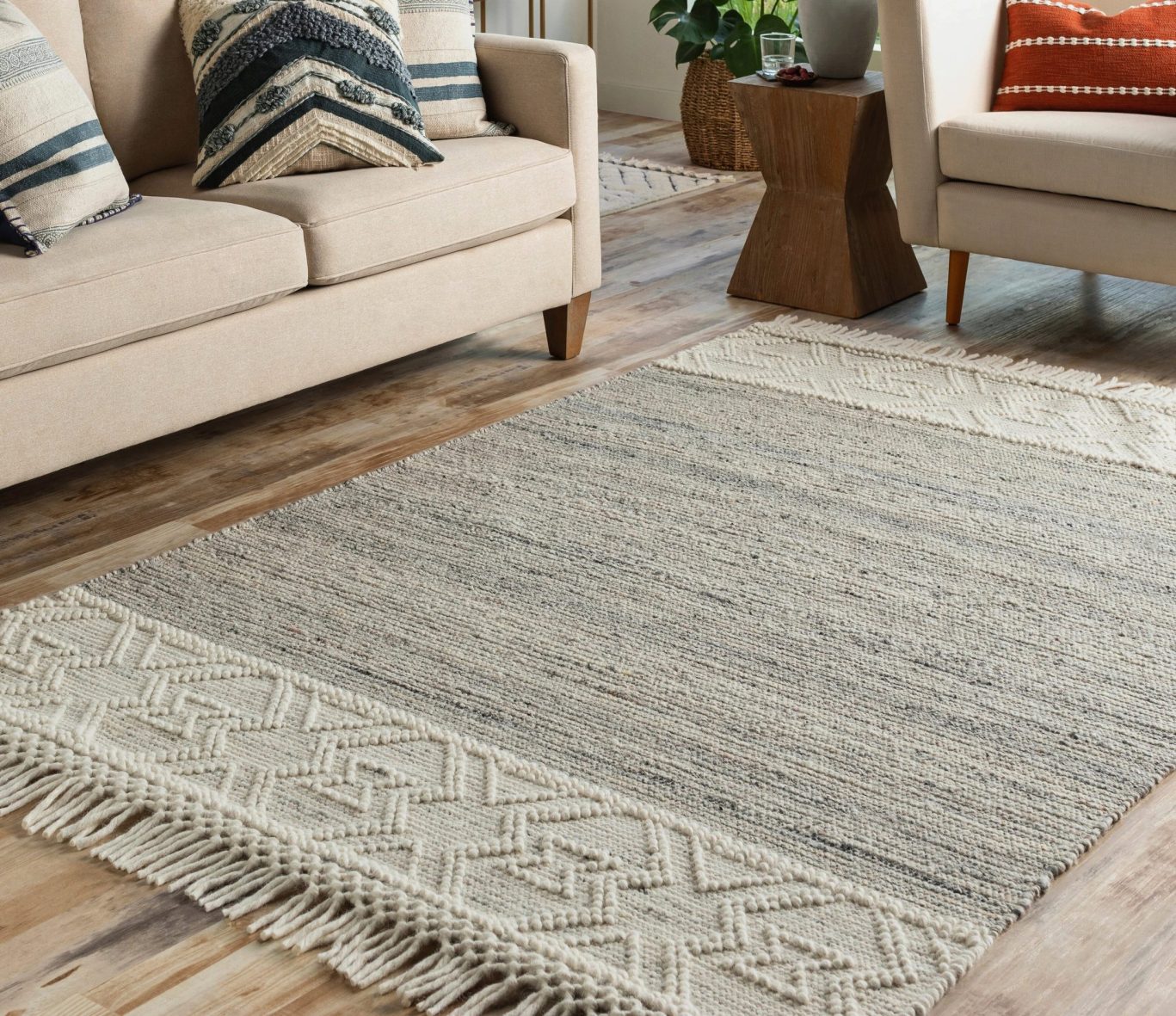Textured beige and cream woven rug in a warm and modern living space.
