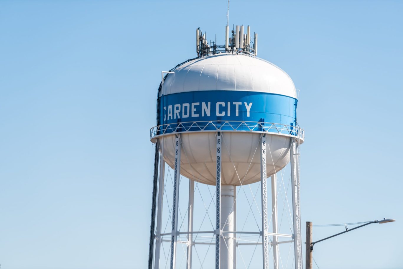 Garden City water tower against a clear blue sky.