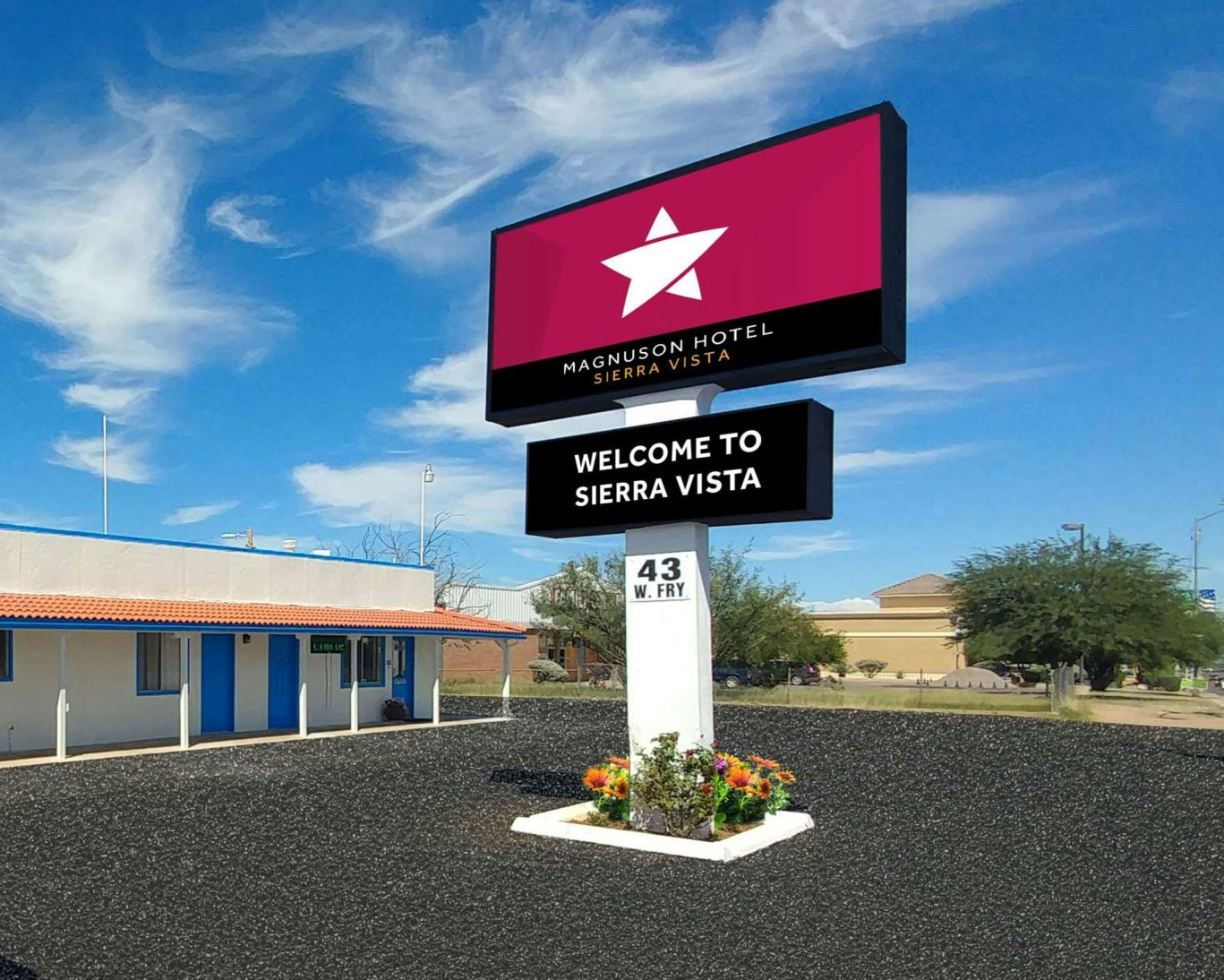 Magnuson Hotel Sierra Vista roadside sign with welcome message under clear blue sky in Arizona.