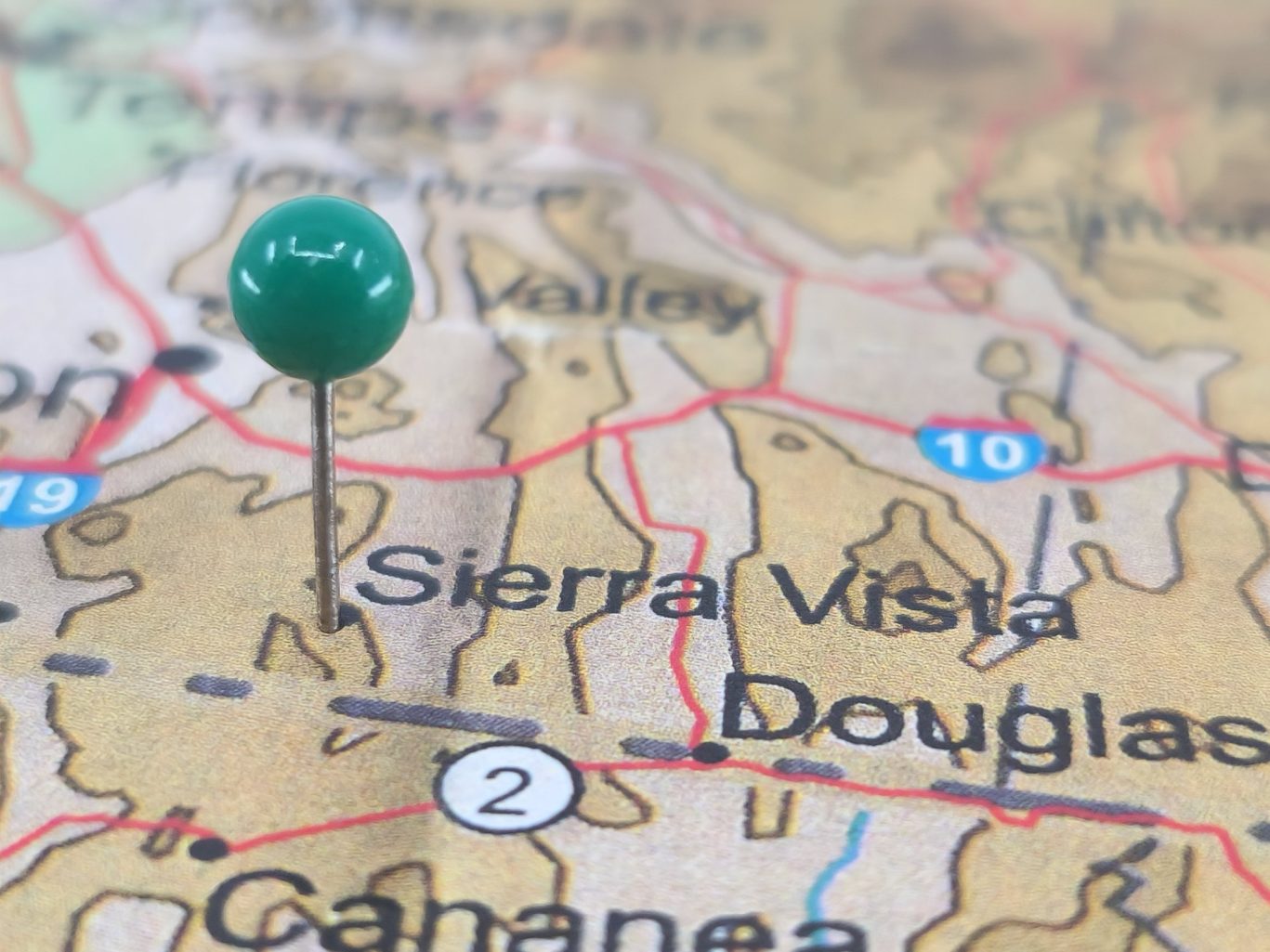 Close-up of a map with green pushpin marking Sierra Vista, Arizona near Douglas and U.S. Route 10.