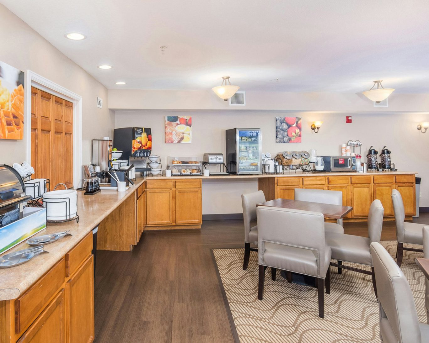 Complimentary hotel breakfast area with buffet station and dining tables in Manitou Springs.