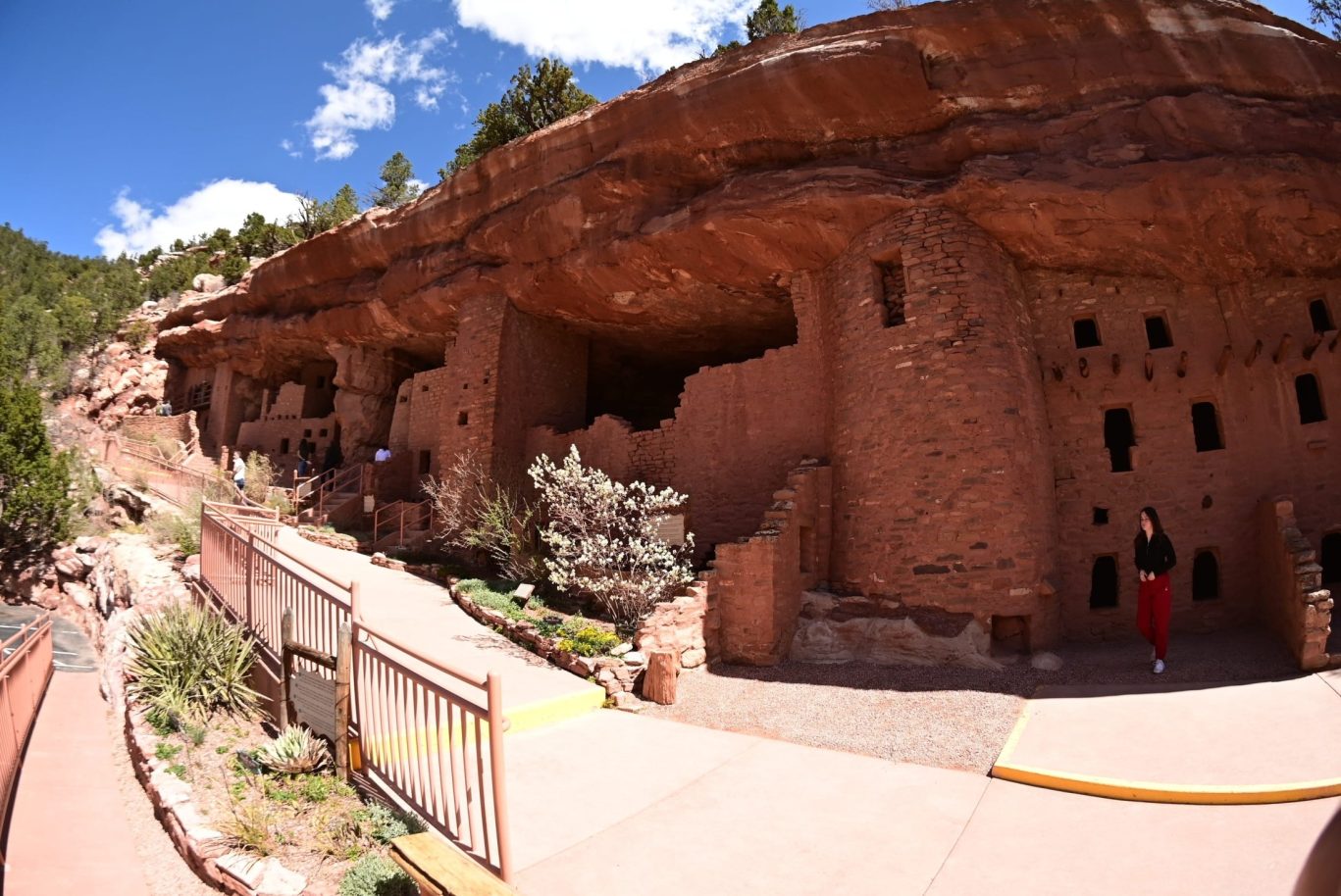 Historic Manitou Cliff Dwellings under red sandstone overhang near Colorado Springs.