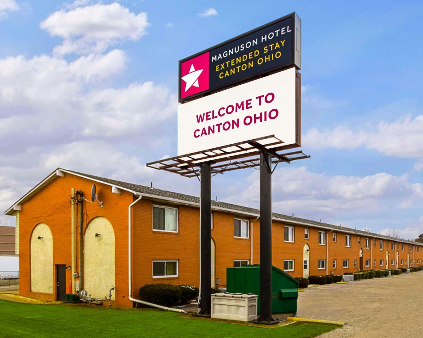 Exterior view of Magnuson Hotel Extended Stay Canton Ohio with large welcome sign.