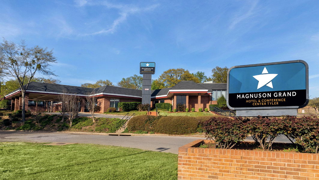 Magnuson Grand Hotel and Conference Center Tyler Texas exterior view with signage and landscaped entrance.