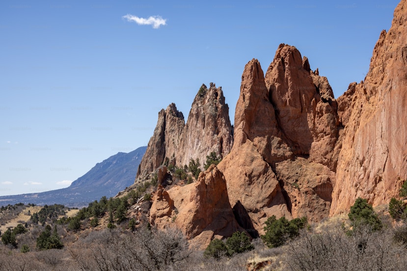 Striking red rock formations in a desert landscape under a clear blue sky.