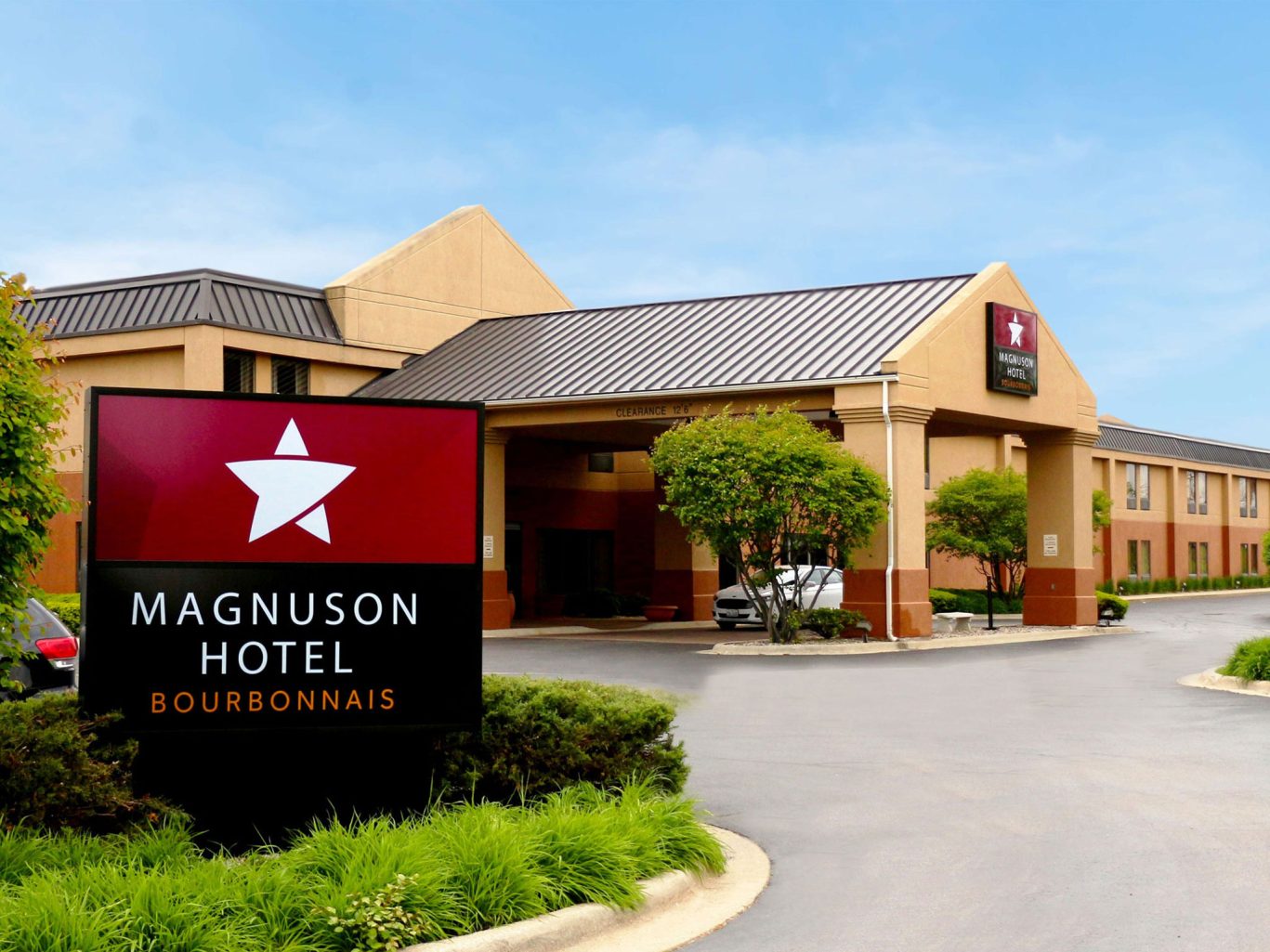 Exterior view of Magnuson Hotel Bourbonnais with clear signage and landscaped entrance.
