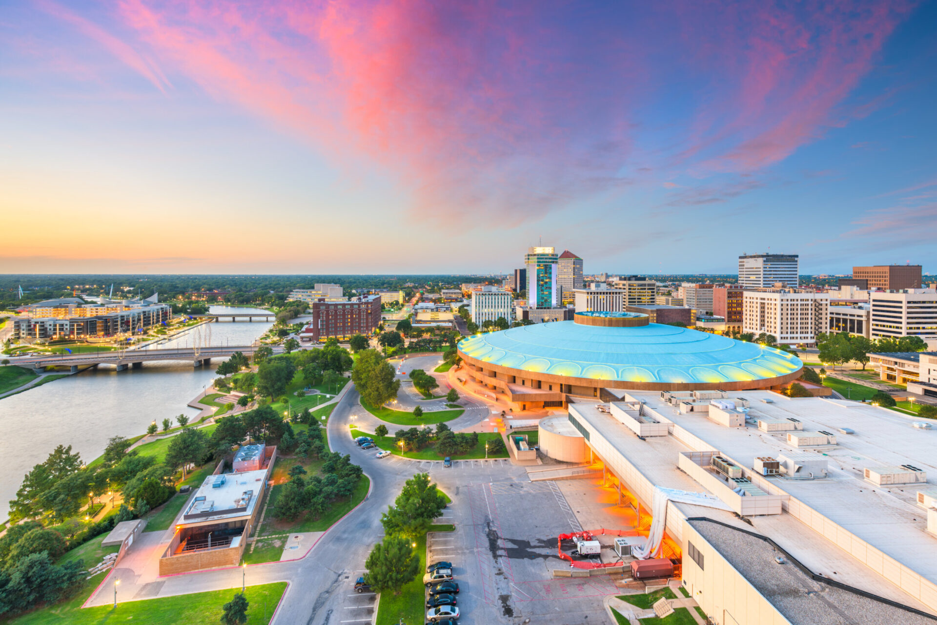 Aerial view of Wichita Kansas skyline at dusk with downtown buildings and Arkansas River