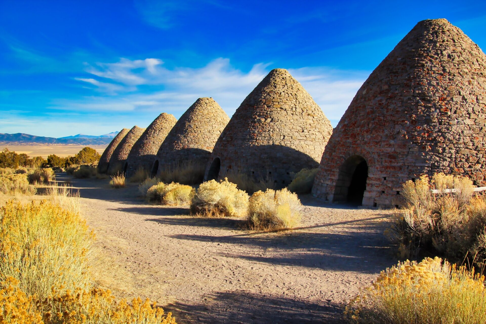 Row of historic Ward Charcoal Ovens surrounded by desert brush near Ely, Nevada